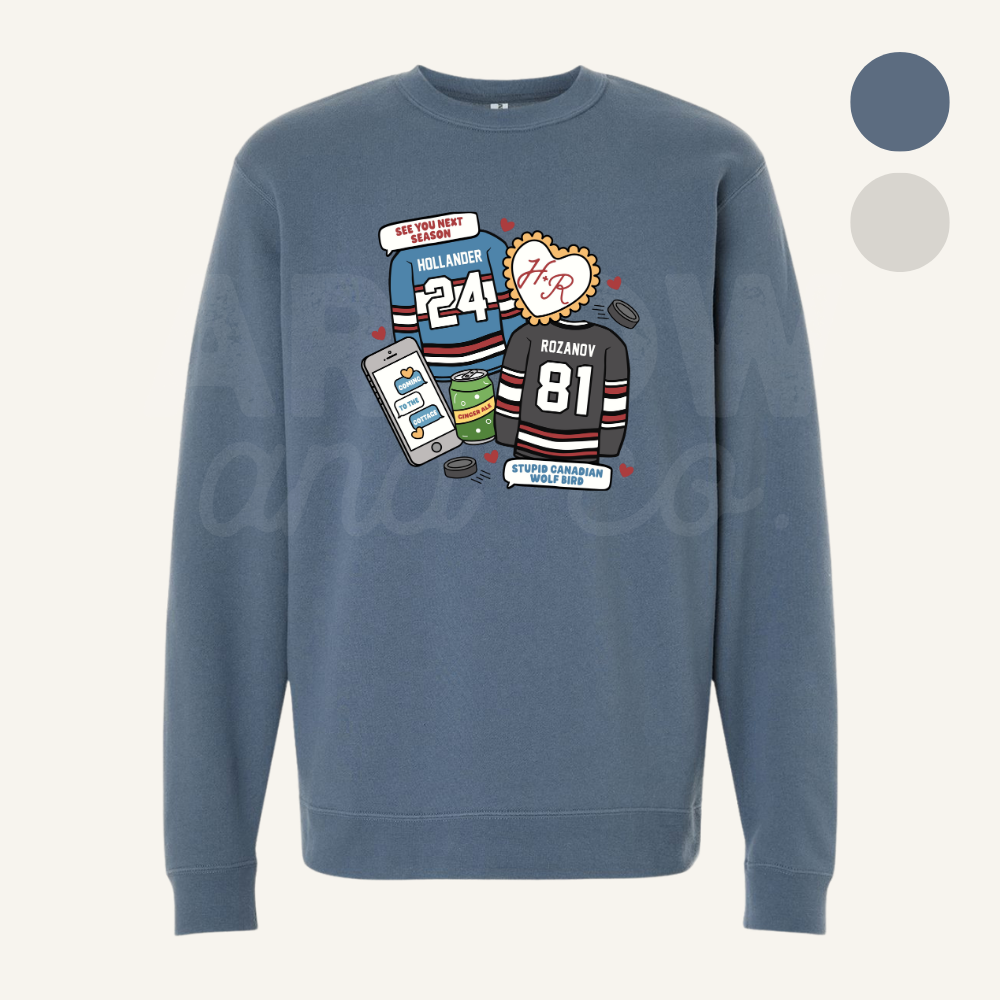 Blue sweatshirt with hockey sports-themed graphics on a white background